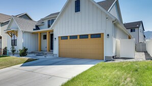 A single-story house with a garage, a front porch, and a small front yard. - Quiet Tooele Retreat w/ Games + Fireplace (Tooele)