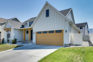 A single-story house with a garage, a front porch, and a small front yard. - Quiet Tooele Retreat w/ Games + Fireplace (Tooele)