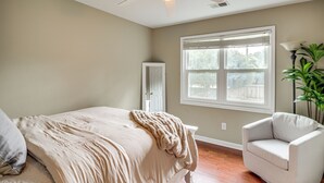 A bedroom with a bed, a chair, a window, and a ceiling fan. - 8 Mi to Marietta: Spacious Powder Springs Home (Powder Springs)