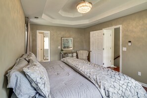 A bedroom with a large bed, a chair, and a desk. - Peaceful Cobb County Base Near Atlanta Attractions (Powder Springs)