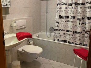 A bathroom with a sink, toilet, and bathtub. - Roda Mulin, Surcuolm, (Surcuolm), 38010B by Interhome (Obersaxen Surcuolm)