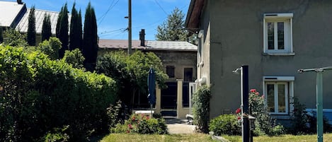 A residential property with a front yard, a pathway leading to the entrance, and a small garden area.