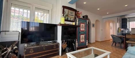 A living room with a television, a coffee table, and a cabinet.