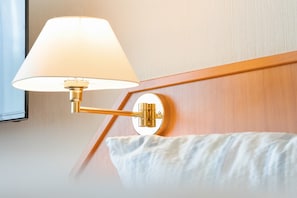 A wall-mounted lamp with a white shade and a brass fixture.