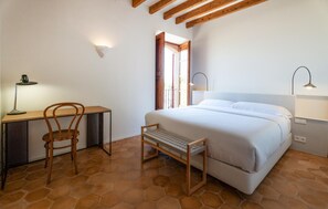 A bedroom with a bed, a desk, a chair, a bench, and a window. - Stunning home in Santa Maria (Santa Maria)