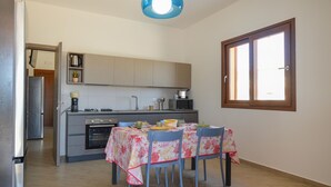 A compact kitchen with a dining area, a window, and a ceiling light fixture. - 2 bedroom nice home in Balestrate (Balestrate)