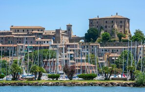 A coastal town with historic buildings, a prominent tower, and a marina with numerous boats. - 3 bedroom pet friendly home in Arrone (TR) (Arrone (TR))