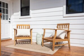 Two wooden chairs with cushions on a wooden deck, a white door, and a window with blinds. - The Vina {B} - A Coastal Downtown SB Retreat (Santa Barbara)