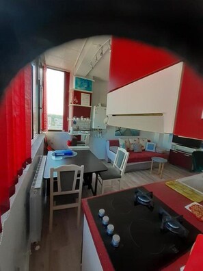 A compact living space with a dining area, kitchenette, and seating area. - Cozy 1-bedroom apartment in gorgeous Constanta with AC (Constanta)