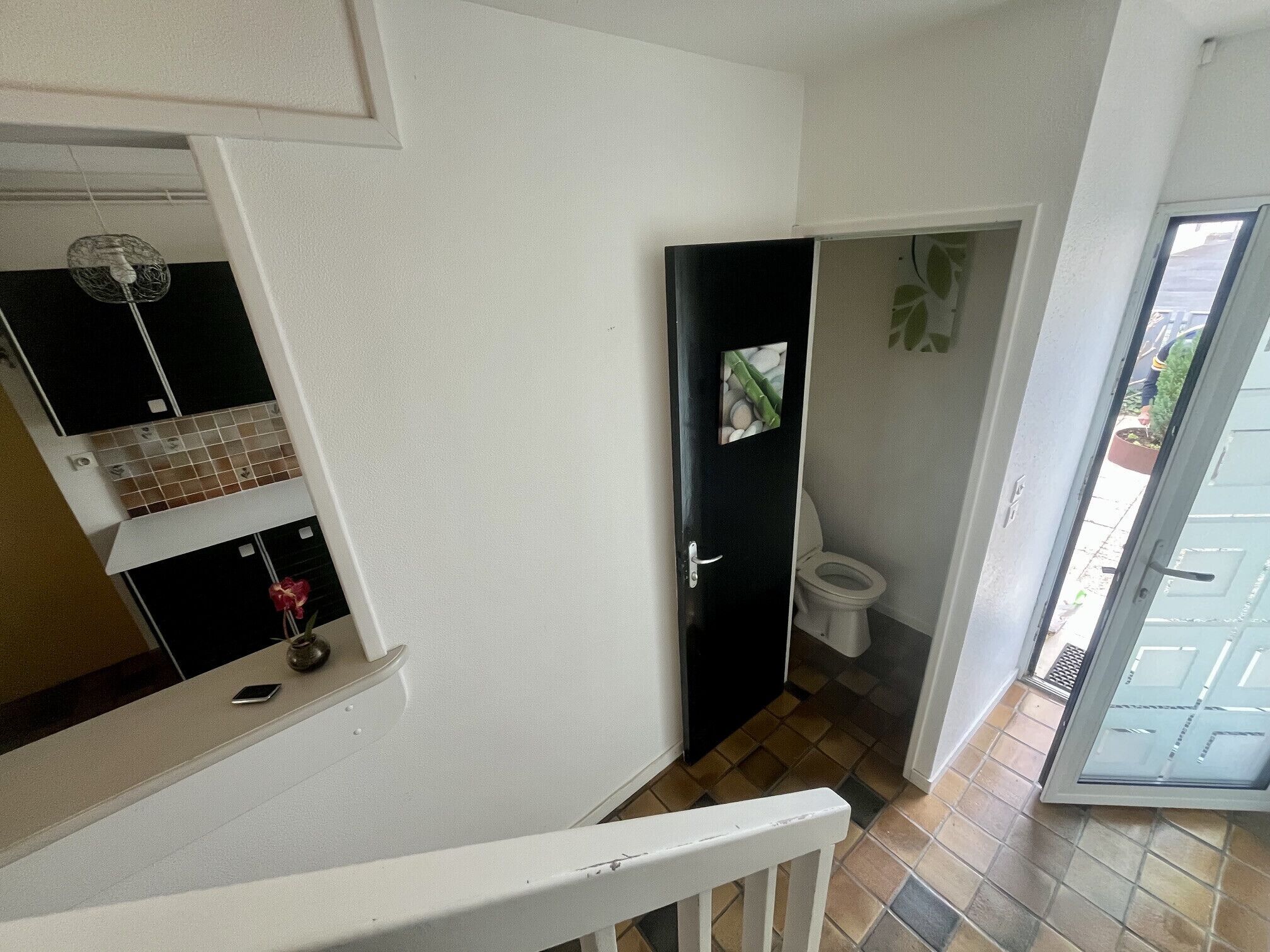 A bathroom with a toilet, a sink, and a shower area.