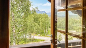 A wooden-framed window with a view of a forested landscape and mountains. - Stunning home in Bjorli with WiFi (Bjorli)