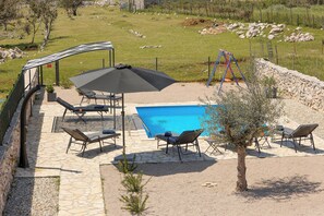 A backyard with a swimming pool, outdoor seating, and a fenced area. - Island Krk Villa Niko PET FRIENDLY 200meters from hidden sandy beachPET FRIENDLY (Krk)