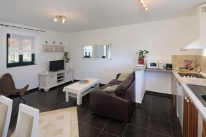 A modern living room with a sofa, coffee table, and entertainment unit. - Island Krk Villa Niko PET FRIENDLY 200meters from hidden sandy beachPET FRIENDLY (Krk)