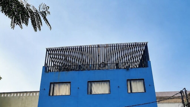 A multi-story building with a blue facade, featuring a sign for 'MISTY PRIME' which advertises AC rooms, a restaurant, and a banquet hall. - Hotel Misty Prime (Indore)
