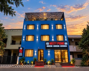 A hotel named 'Misty Prime' with a blue facade, multiple windows, and a checkered entrance. - Hotel Misty Prime (Indore)