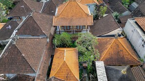 A traditional building with multiple roof levels and a central courtyard with plants. - Ubud Heritage Stay (Gianyar)