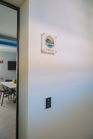 A wall-mounted sign with a logo and the name 'Sapphire' in a hotel setting.