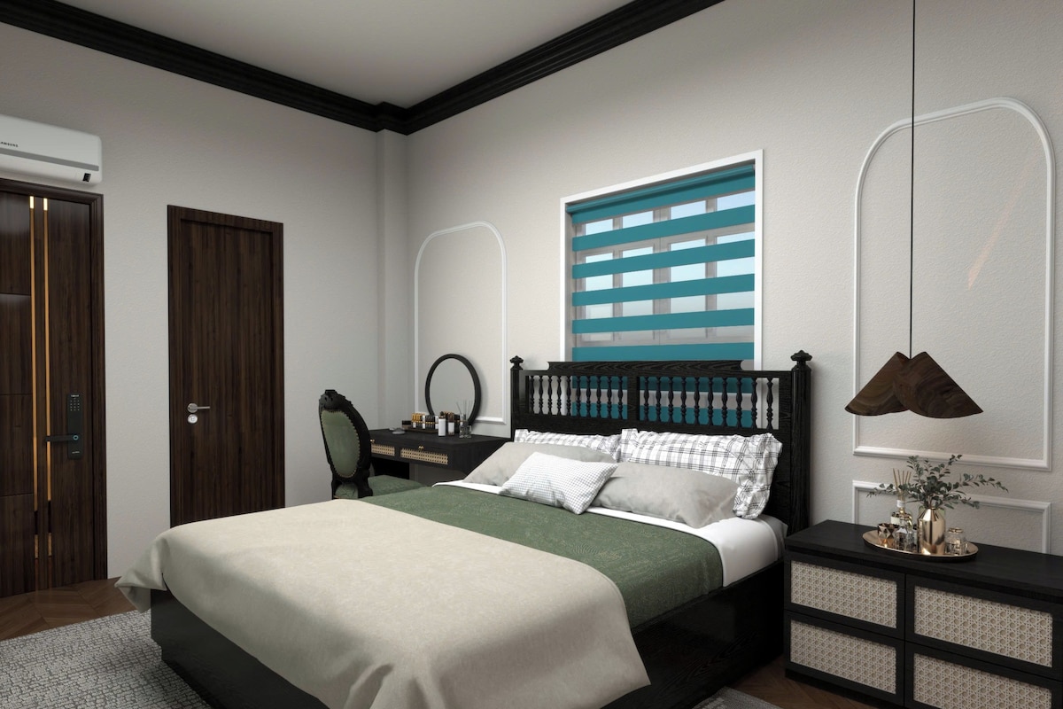 A bedroom with a bed, bedside table, dresser, mirror, and a window with blinds.