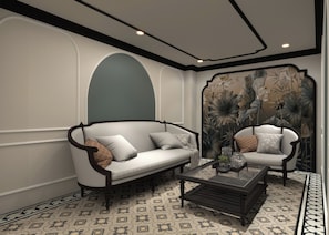 A room with a sofa, armchair, and a coffee table. - De Rond du Lac (Ba Đình)
