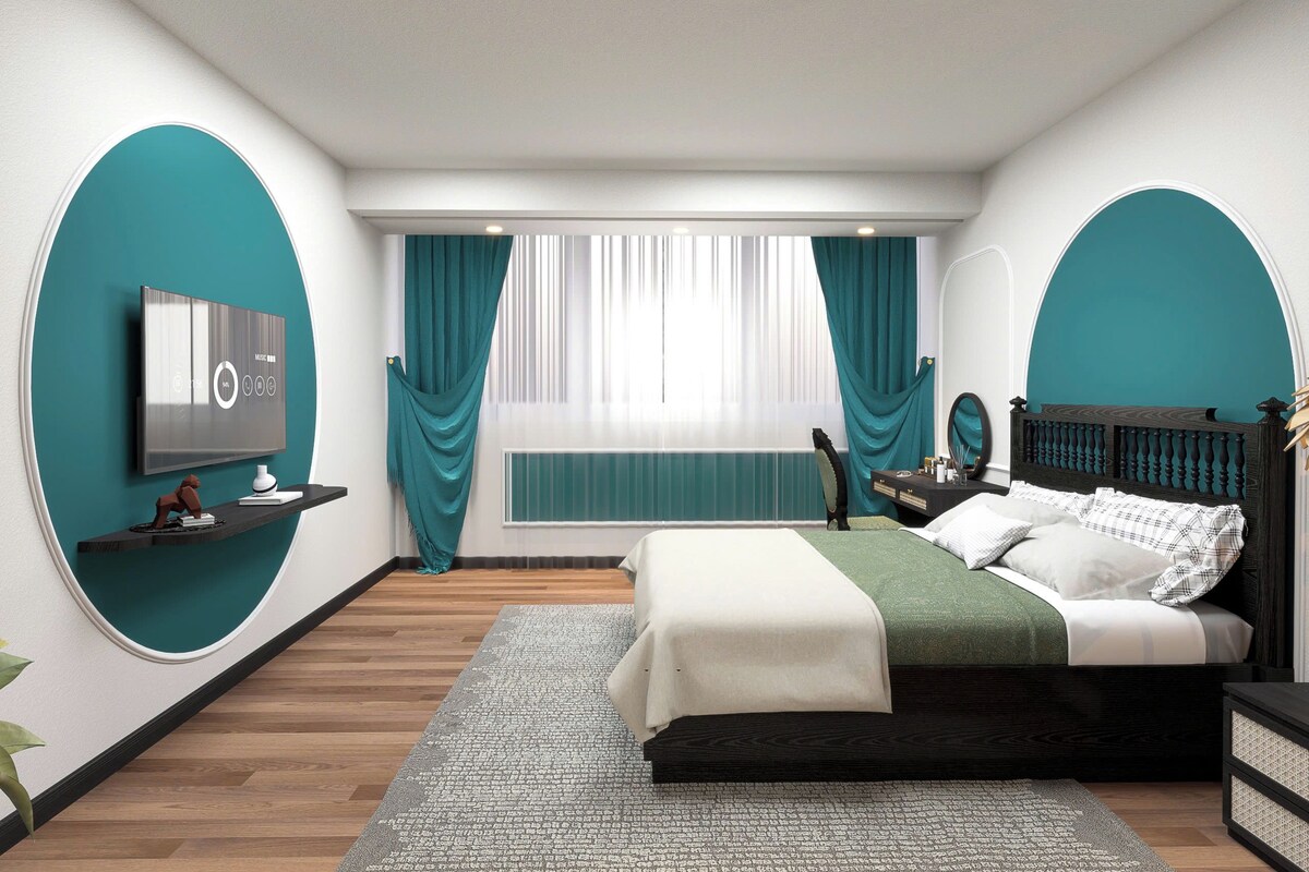 A modern bedroom with a bed, a TV, a window with curtains, and a bedside table.