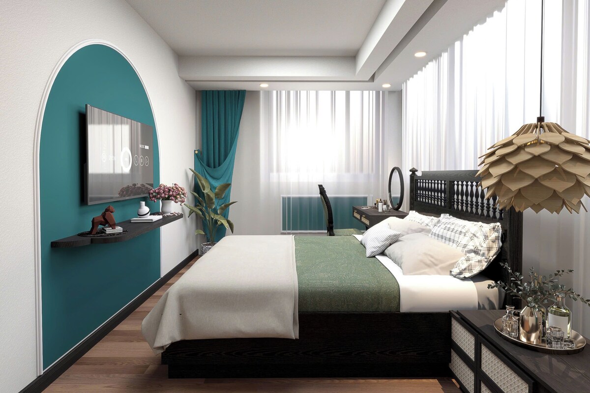 A modern bedroom with a bed, bedside table, and a large window.