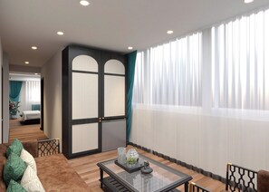 A modern hotel room with a glass coffee table, a sofa with patterned cushions, a bed with a wooden headboard, and a large window with sheer curtains. - De Rond au Lac (Hanoi)