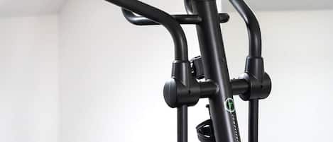 A stationary bike with a digital display and handlebars.