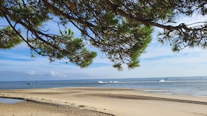 A beach with clear skies, calm water, and boats in the distance. - Apartment 'Carpe Diem' with Bassin View, Balcony and Wi-Fi (Arcachon)