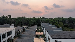 A residential area with multiple houses, each featuring a sloped roof and a balcony.