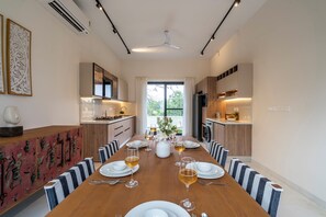 A modern kitchen with a dining area set for a meal.