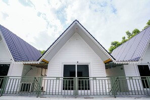A building with a symmetrical facade, a central entrance, and a gated driveway. - FabHotel Hill View Cottages (Arpora)