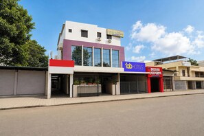 A building with a sign for 'Fab Hotels' and another for 'Nutan Lodging.' - Via Nutan Lodging (Pune)