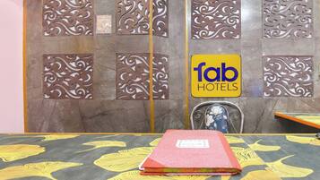 A hotel reception area with a sign for 'fab hotels' and decorative metal panels.