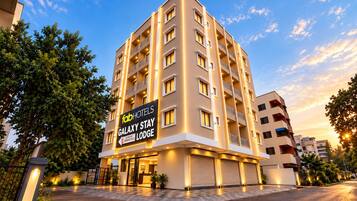 A multi-story hotel building with a sign for 'fabHOTELS Galaxy Stay Lodge'.
