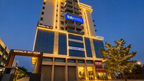 A multi-story hotel with a prominent 'fabHOTELS' sign, a 'Shivalik Sky Park' entrance, and a 'Yogeshwar Group' sign. - FabHotel Nashik Prime Stay (Nashik)