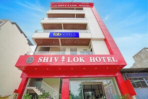 The exterior of Shiv Lok Hotel with a prominent red facade and a blue sign for Fab Hotels. - Fabhotel Shivlok (Bhopal)