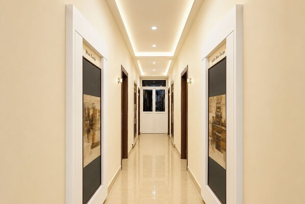 A hallway with doors labeled 'Photo Temple' and 'Golden Hour Escape,' leading to a room with a view.