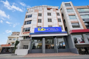 A multi-story building with a prominent 'fabHOTELS' sign.