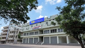 A multi-story hotel with a prominent 'fab hotels' sign, a 'Olympio Hotel Premium Rooms' sign, and a staircase leading to the entrance. - Fabhotel Olympio (Hyderabad)