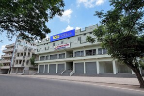 A multi-story hotel with a prominent 'fab hotels' sign, a 'Olympio Hotel Premium Rooms' sign, and a staircase leading to the entrance. - Fabhotel Olympio (Hyderabad)