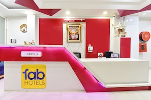 A reception desk with a 'fab hotels' sign, a 'CEPTION' label, and a framed picture on the wall. - FabHotel Pacific View (Jaipur)
