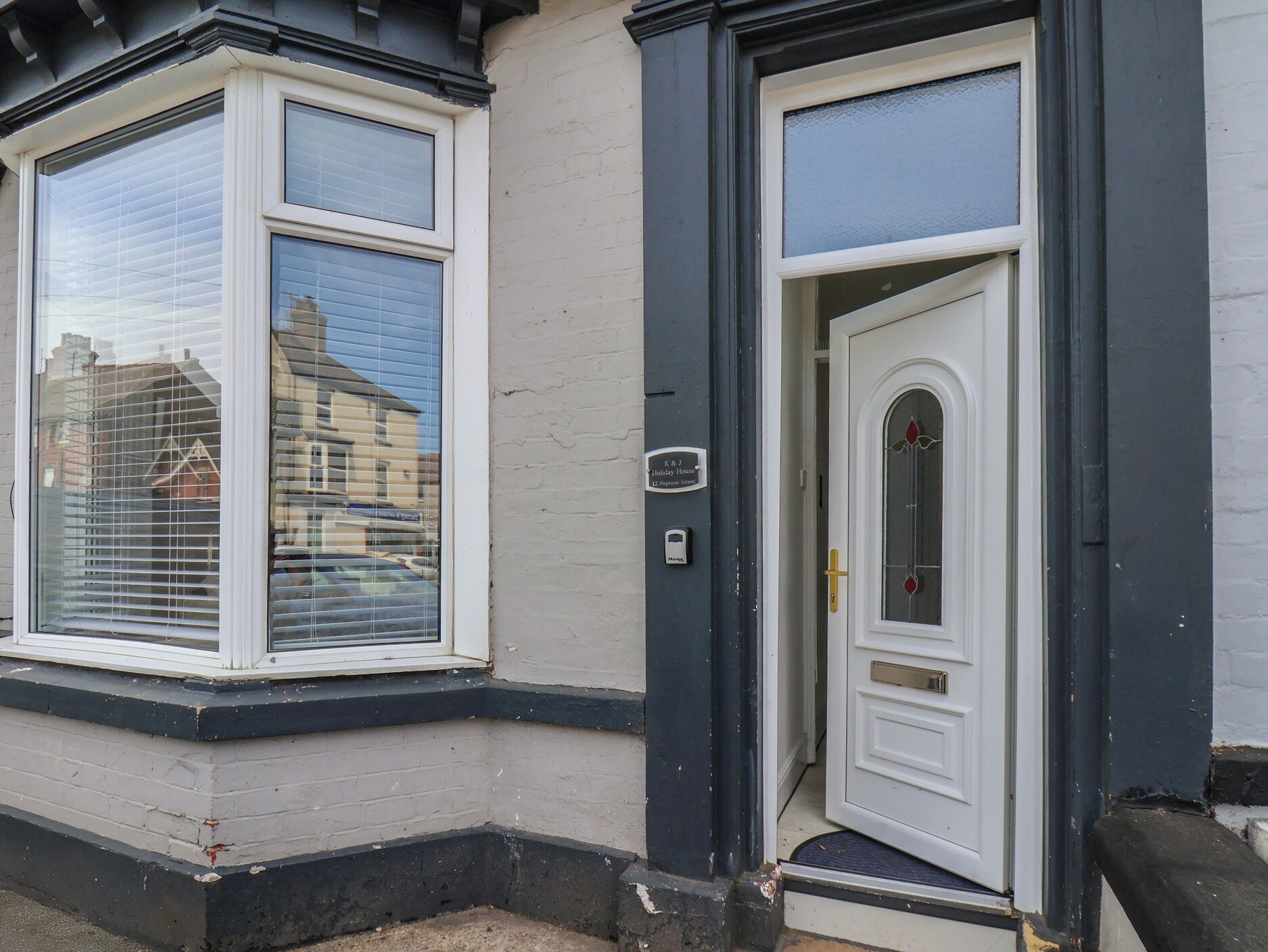 A residential property with a bay window and a front door.
