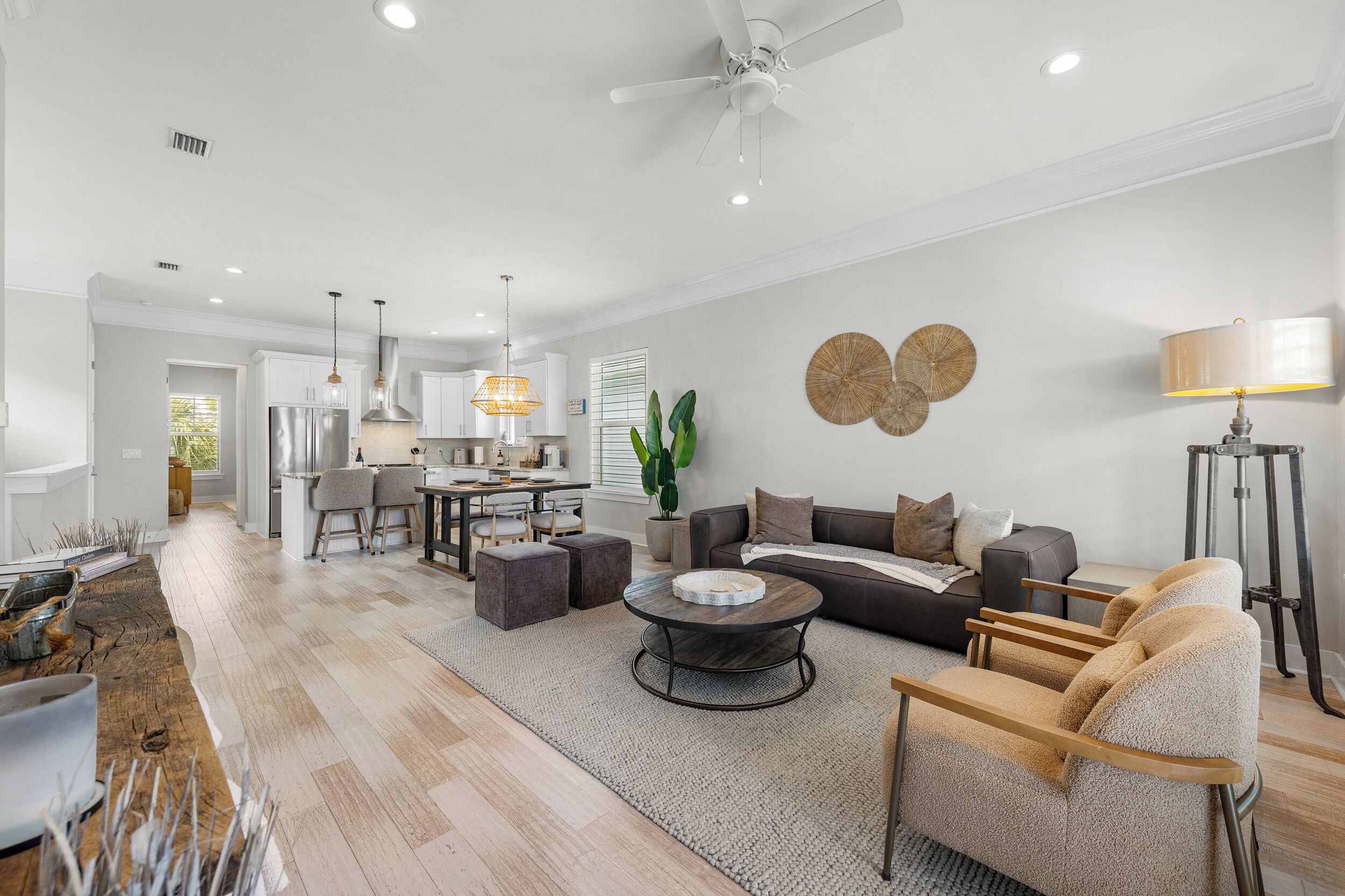 A spacious living area with a sofa, coffee table, and a dining area with chairs and a table.