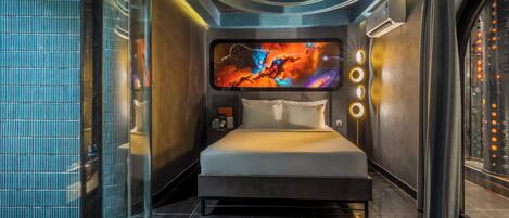 A modern bedroom with a large bed, a wall-mounted TV, and a circular ceiling design.
