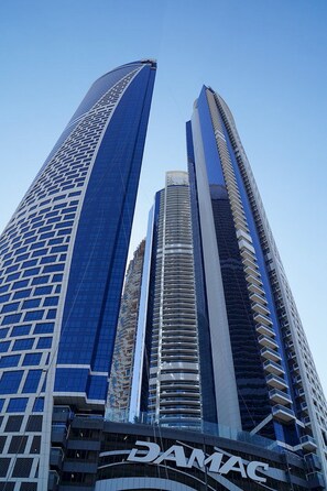 A high-rise building with a prominent DAMAC logo at the base. - Luxury 1BR at Paramount Residences with  (Dubai)