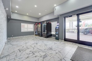 A clean, modern indoor area with a marble floor, vending machines, and an ATM. - King bed suite with Kitchenette (Memphis)