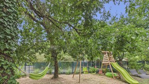 A playground with a slide, swings, and a hammock. - Pool, garden & kids’ games – House for 6 (Lanton)