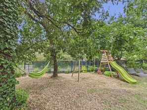 A playground with a slide, swings, and a hammock. - Pool, garden & kids’ games – House for 6 (Lanton)