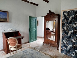 A room with a desk, chair, open green door, and a mirror with a peacock design. - Large Country House (Brouzet-lès-Alès)