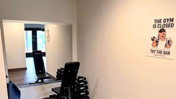 A gym area with exercise equipment and a sign indicating the gym is closed.